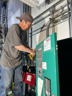 Quantum Wave Electric technician servicing a Kohler transfer switch in Alaska
